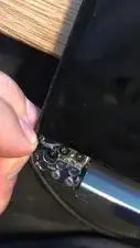 Look For black Plastic Strips, This will allow you to remove the adhesive the easy way, so be gentile. Slowly pull on them until most of the adhesive is removed. Similar to apple Battery Tabs